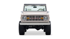 Front view of a Classic Ford Bronco in dove gray with beige interior and black roof