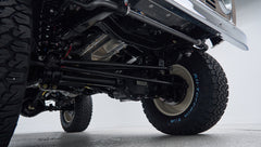 Front suspension and differential components visible under lifted Classic Ford Bronco