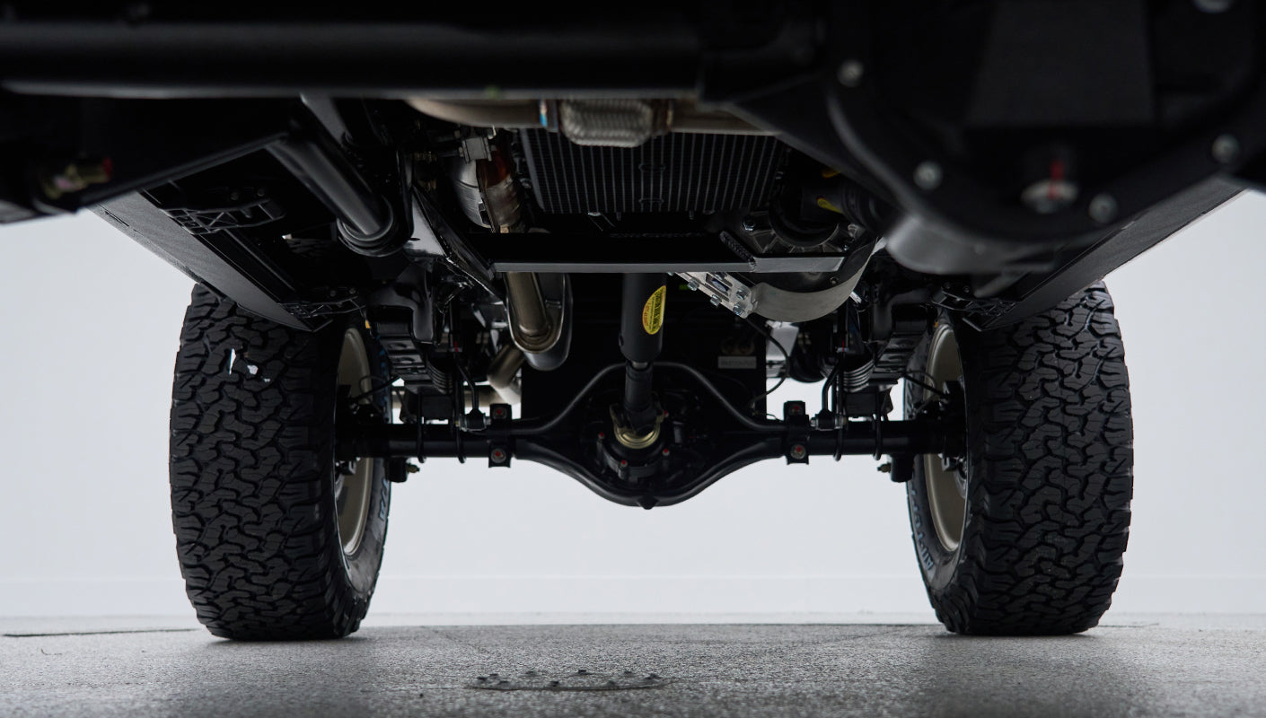 Underside view showing rear axle and tires with suspension details