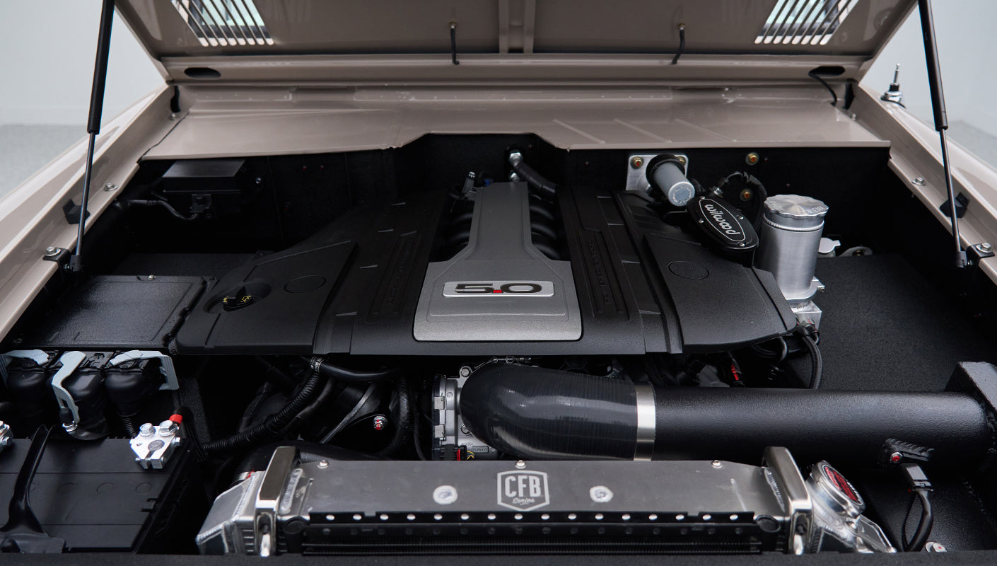 Close-up of 5.0-liter engine with CFB radiator and intake parts under hood