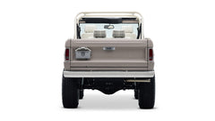 Rear view of Classic Ford Bronco in dove gray showing Ford emblem and license plate