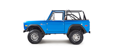 Classic Ford Bronco blue driver side profile showing lifted suspension and rugged tires