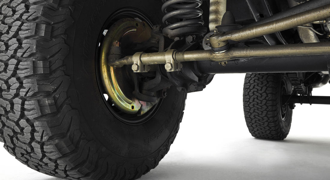 Close-up of the front left tire and suspension system of a Classic Ford Bronco