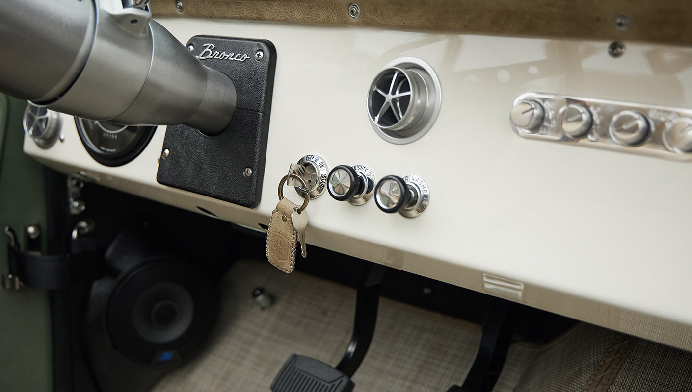 Dashboard of Classic Ford Bronco with ignition keys and control knobs visible