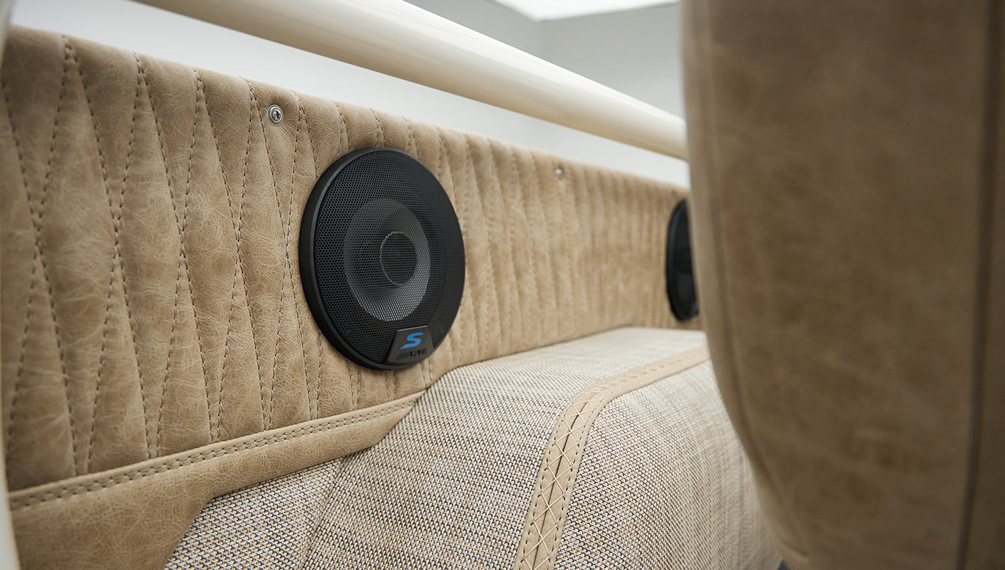Close-up of black speaker on tan rear interior panel of Classic Ford Bronco