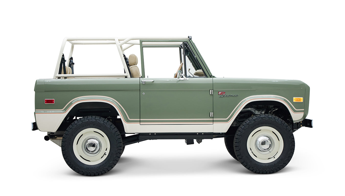 Classic Ford Bronco side profile with lifted suspension and beige seats