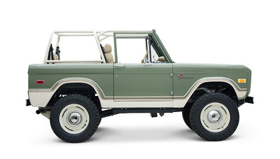 Classic Ford Bronco side profile with lifted suspension and beige seats