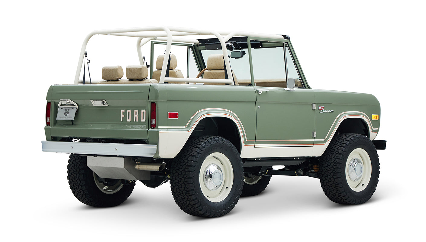 Classic Ford Bronco rear three-quarter view displaying white roof frame and beige interior