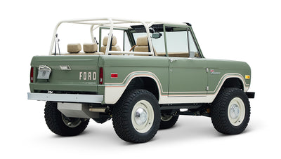 Classic Ford Bronco rear three-quarter view displaying white roof frame and beige interior