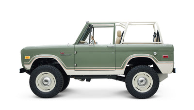 Side view of classic Ford Bronco showing boxwood green body and white lower trim