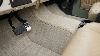 Side view of front seats in tan leather upholstery inside Classic Ford Bronco