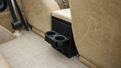 Close-up of rear seat cup holders and beige carpeted floor in Classic Ford Bronco interior