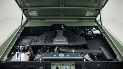 Open hood view showing engine compartment of a Classic Ford Bronco in Boxwood Green