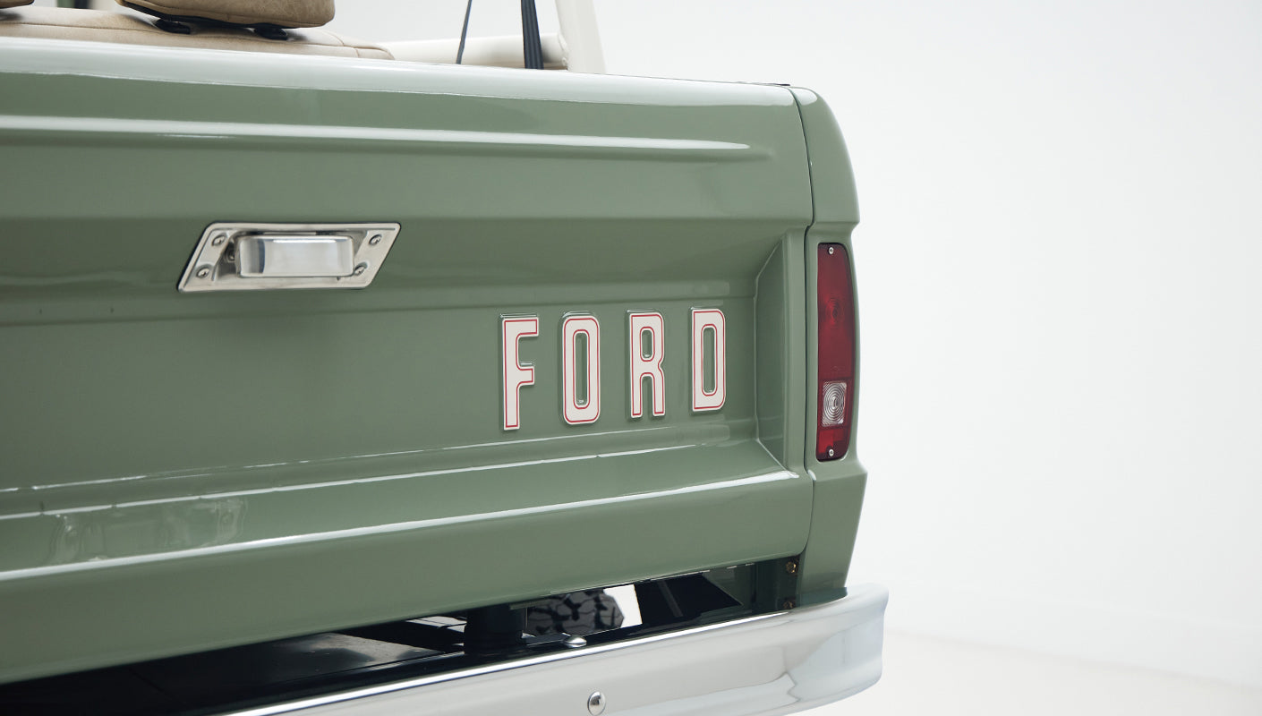 Boxwood Green tailgate with white decal letters spelling FORD on Classic Ford Bronco