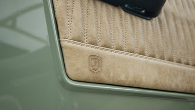 Close-up of tan quilted door panel with CFR Coyote logo on Classic Ford Bronco