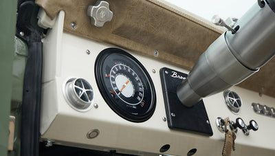 Dashboard of Classic Ford Bronco showing speedometer, steering column, and Bronco emblem