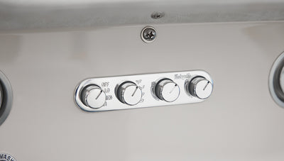 Chrome control panel with four knobs labeled VintageAir mounted on white Classic Ford Bronco dashboard