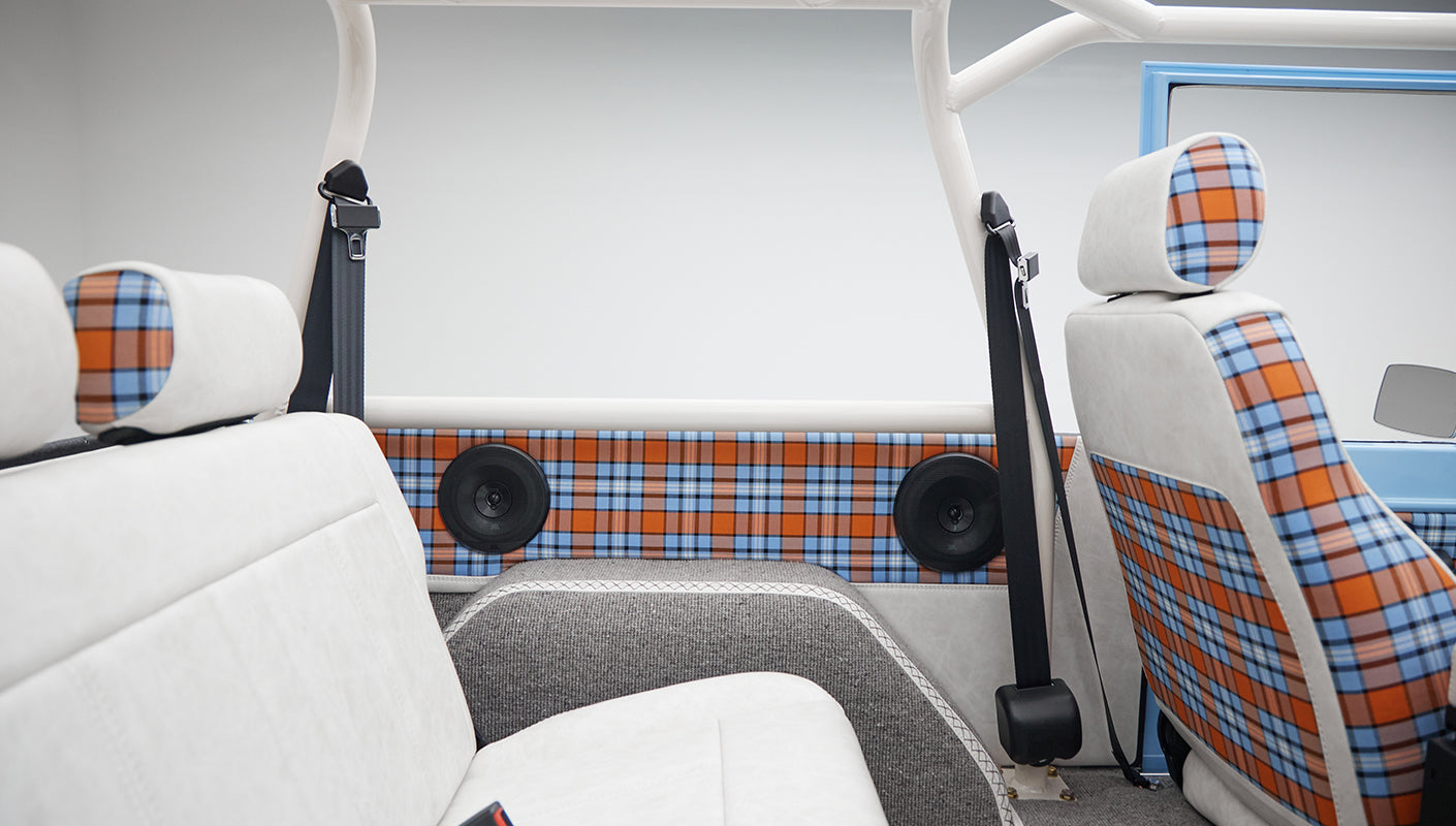 Plaid and white seats with plaid door panels inside Classic Ford Bronco
