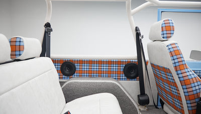 Plaid and white seats with plaid door panels inside Classic Ford Bronco
