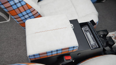Close-up of white and orange blue plaid upholstery on armrest and part of seat in Classic Ford Bronco