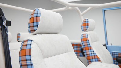 Classic Ford Bronco front seats with white upholstery and orange blue plaid headrests