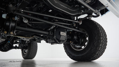 Underneath view of front axle, suspension, and tires of Classic Ford Bronco