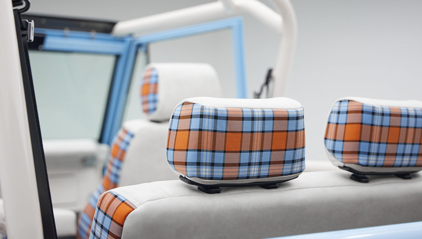 Close-up of Classic Ford Bronco interior plaid pattern on headrests and seats