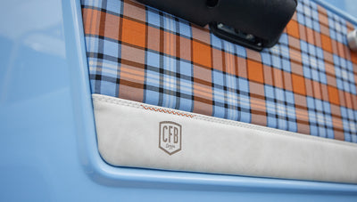 Close-up of Classic Ford Bronco door panel with plaid fabric and CFB Series logo