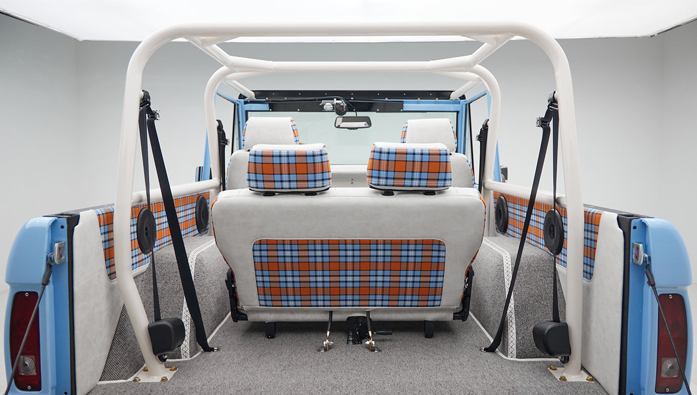 Rear seat and side panels of Classic Ford Bronco featuring blue and orange plaid fabric