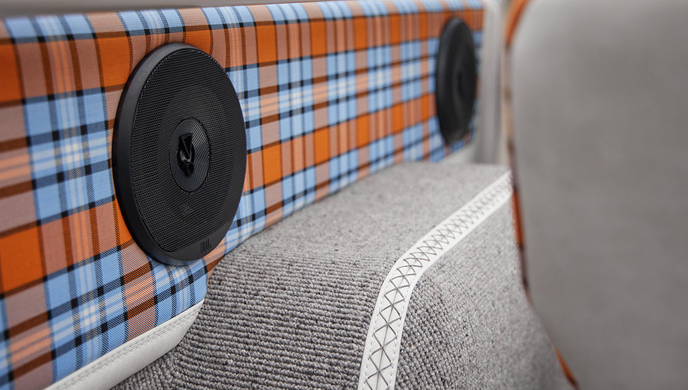 Speakers integrated in plaid fabric-covered rear panels inside Classic Ford Bronco