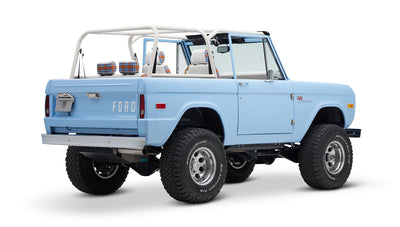 Classic Ford Bronco light blue rear three-quarter angle showing tires and rear tailgate