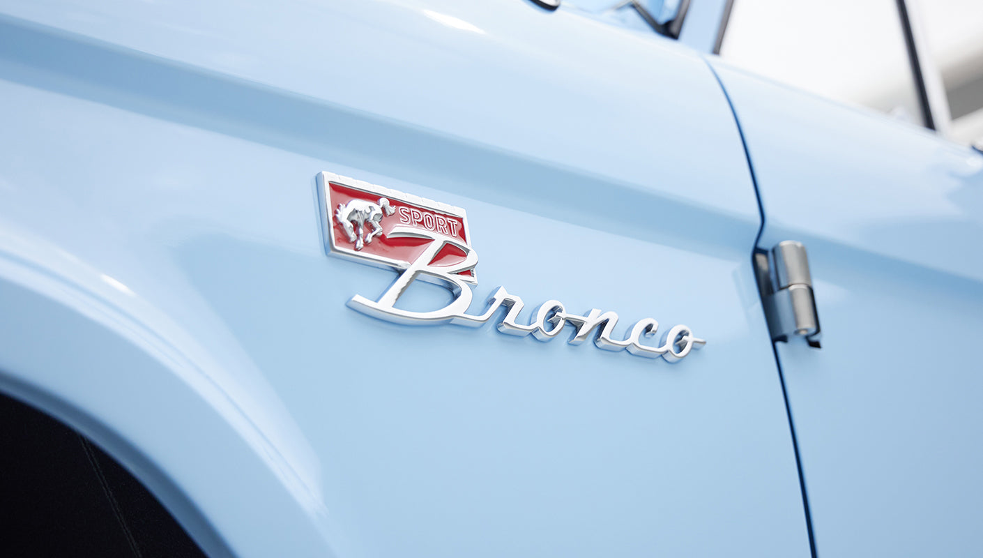 Close-up of Classic Ford Bronco sport emblem and blue paint finish