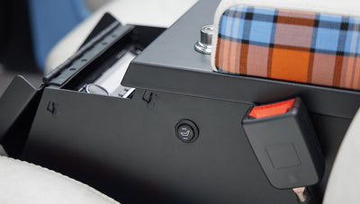 Seat heating control button on side of front seat with plaid fabric in Classic Ford Bronco