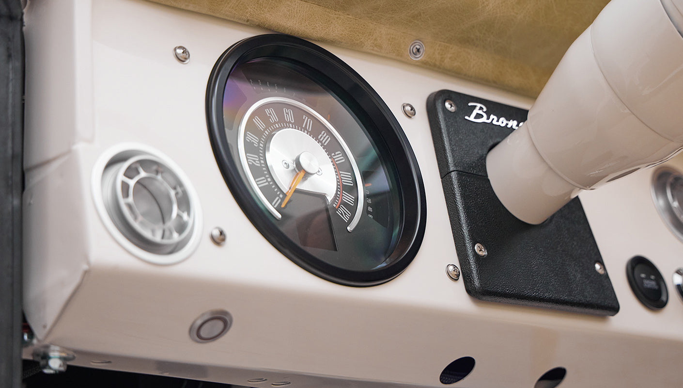 Close-up of Classic Ford Bronco dashboard speedometer and Bronco emblem