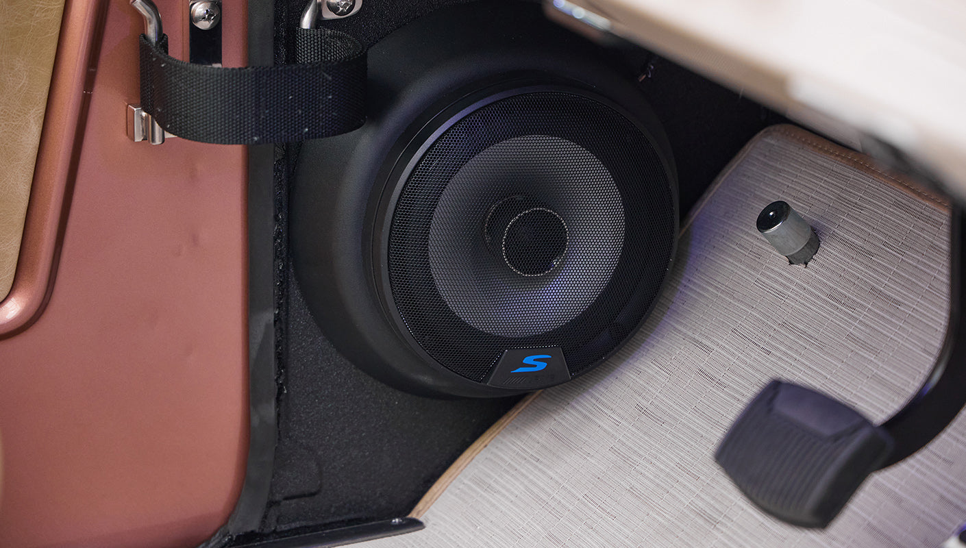 Car audio subwoofer speaker mounted inside Classic Ford Bronco's rear area