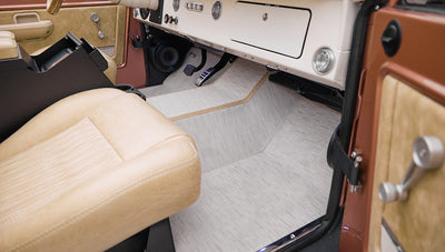 Front passenger seat area showing beige upholstery and tan carpet floor in Classic Ford Bronco