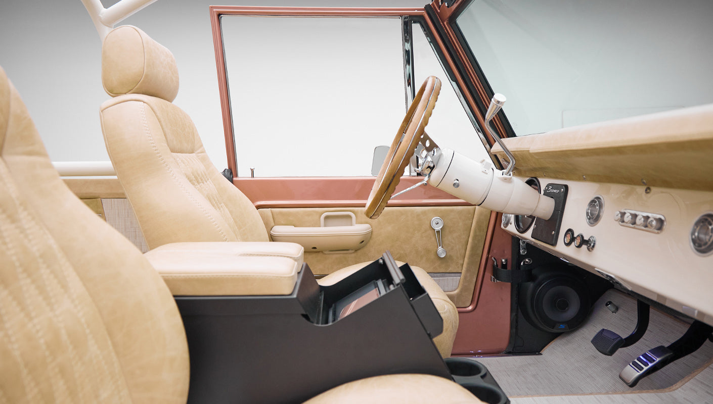 Side interior of Classic Ford Bronco highlighting steering wheel and driver seat