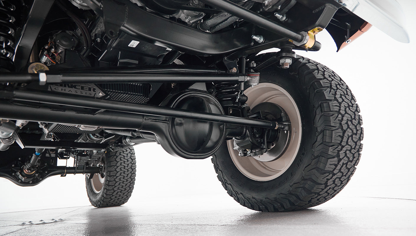 Underside view of suspension and tires on a Classic Ford Bronco showing chassis details