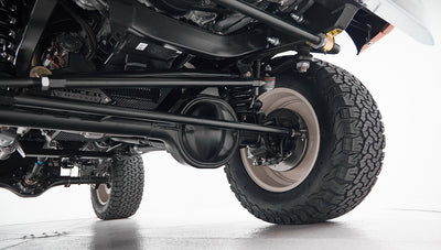 Underside view of suspension and tires on a Classic Ford Bronco showing chassis details