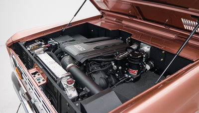 Classic Ford Bronco open engine bay showing modern engine and radiator components