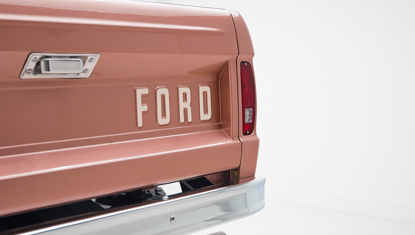 Rear tailgate of Classic Ford Bronco with tan paint and FORD embossed lettering