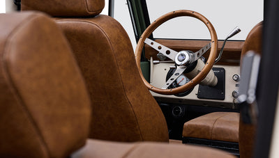 Brown leather front seats and steering wheel inside Classic Ford Bronco