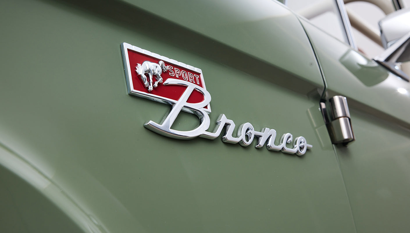Close-up of Classic Ford Bronco emblem on boxwood green painted body.