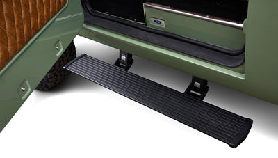 Black AMP Research retractable running board on green door frame of Classic Ford Bronco