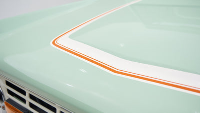 Close-up detail of hood with white and orange pinstriping on porcelain green paint of Classic Ford Bronco