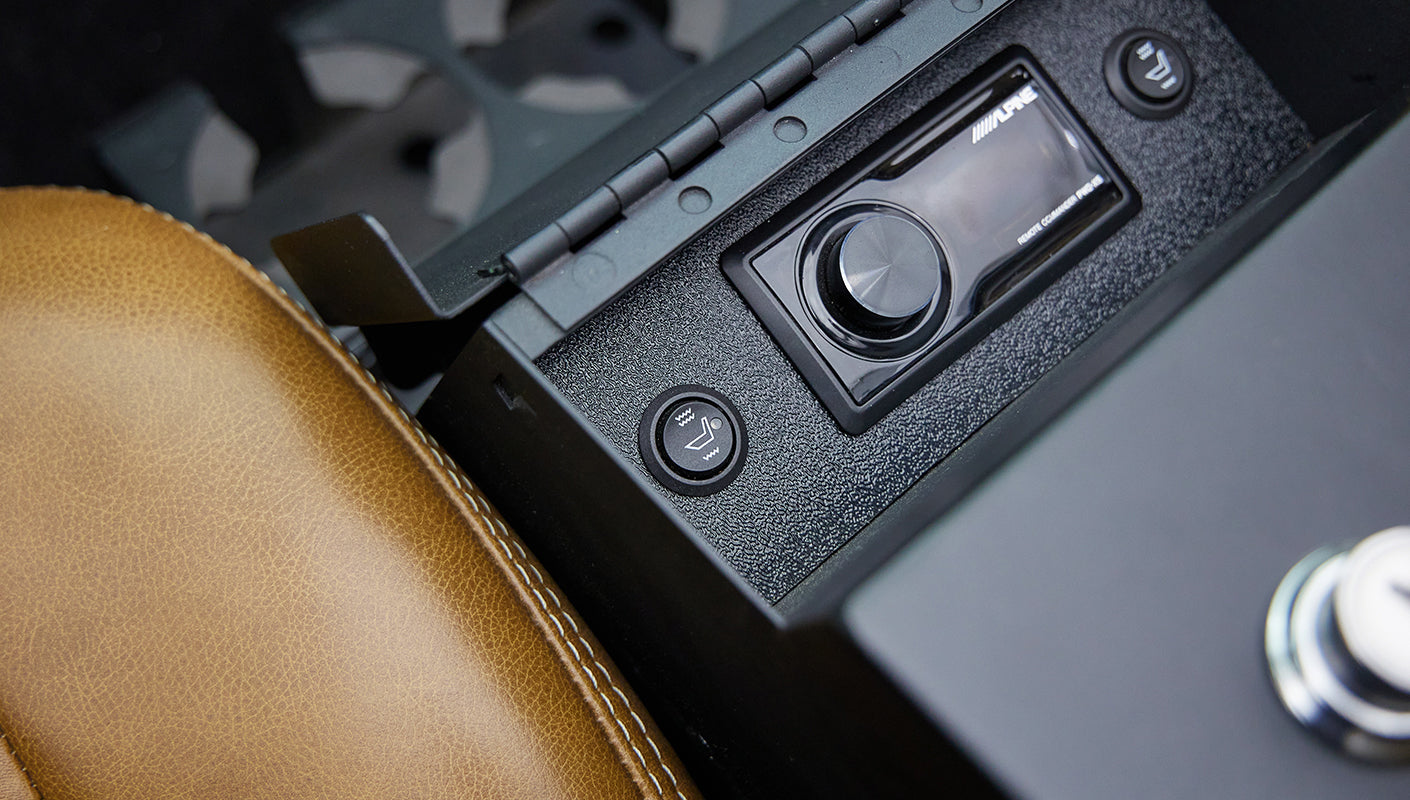 Close-up of seat heating control and audio knob on center console of classic Ford Bronco interior