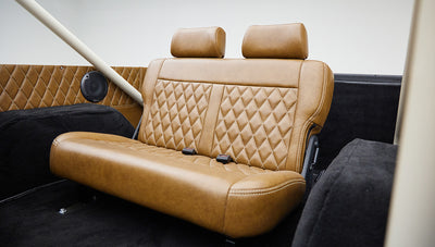 Brown leather rear seat with diamond stitching and headrests inside Classic Ford Bronco