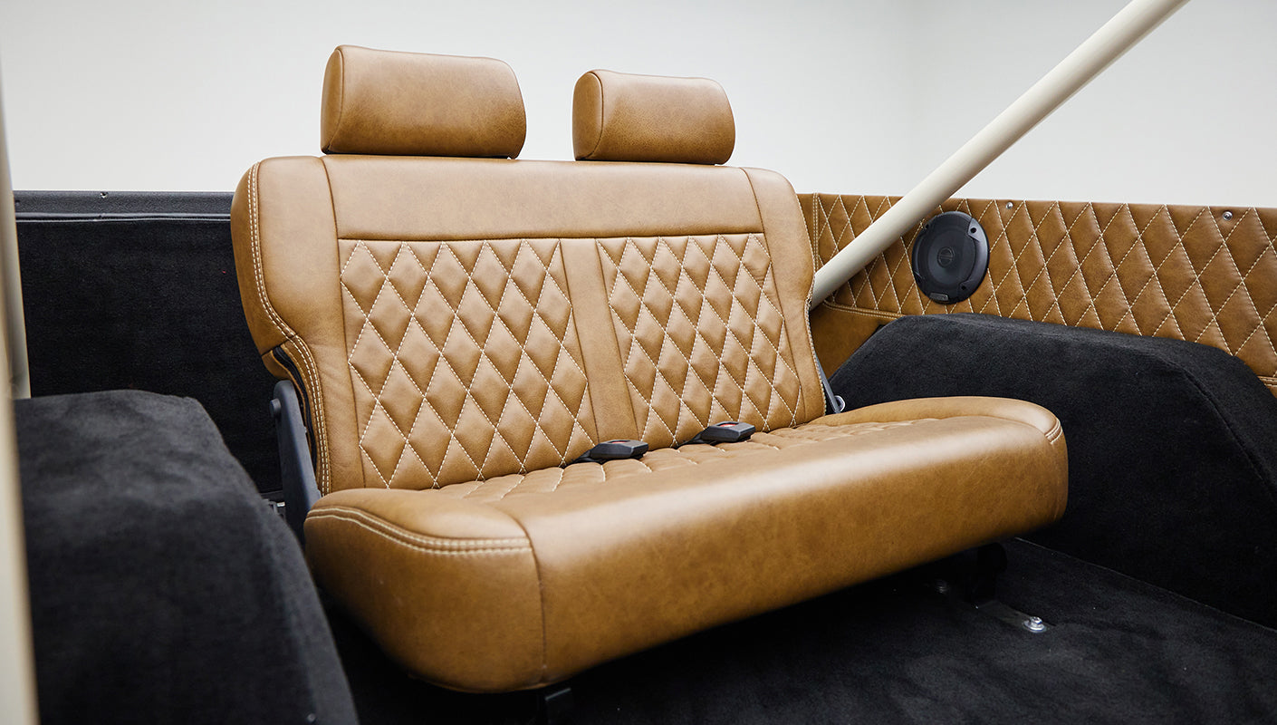 Brown leather front seats with diamond stitching visible inside Classic Ford Bronco