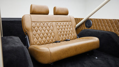 Brown leather front seats with diamond stitching visible inside Classic Ford Bronco
