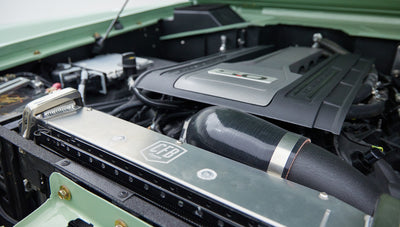 Close-up of power steering components and fluid reservoir with PSC branding in the engine bay of a vehicle